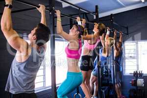 People doing chin-ups while exercising