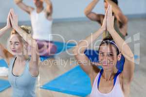 Two beautiful women performing yoga