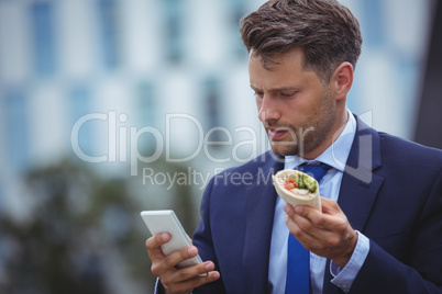 Handsome businessman using mobile