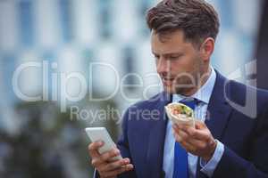 Handsome businessman using mobile