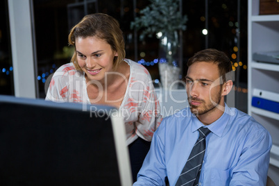 Business executives working on computer