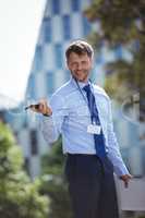 Handsome businessman holding mobile phone and laptop