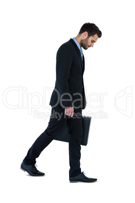 Businessman walking with briefcase