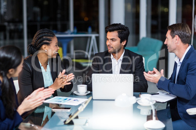 Coworkers applauding a colleague after presentation