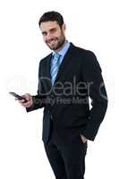 Portrait of businessman text messaging on mobile phone
