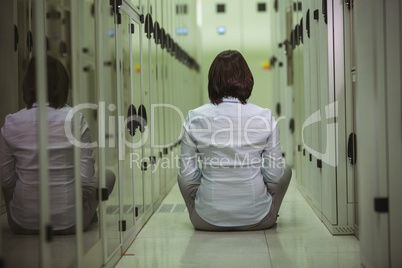 Technician siting on floor in server room