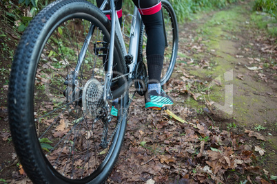 Low section of male mountain biker riding bicycle