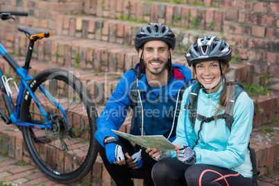 Portrait of biker couple with a map