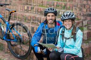 Portrait of biker couple with a map