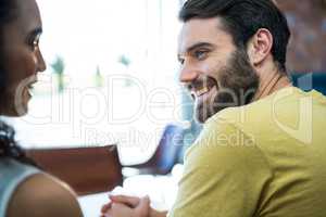 Couple talking to each other in coffee shop