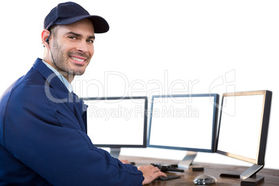 Happy security officer using computer