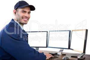 Happy security officer using computer