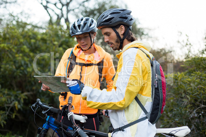 Biker couple looking at a map