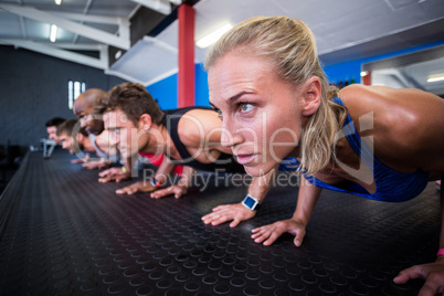 Friends doing push-ups in gym