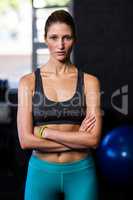 Confident young female athlete in gym