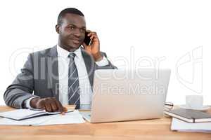 Businessman talking on the phone and using other multimedia devices