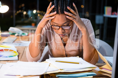 Stressed businesswoman sitting at her desk