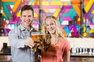 Couple showing a glass of beer in bar