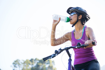 Female cyclist drinking water
