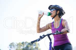 Female cyclist drinking water