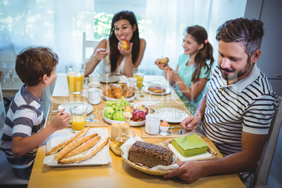 Happy family having breakfast together