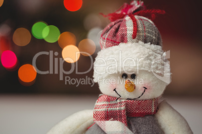 Close-up of snowman on wooden table