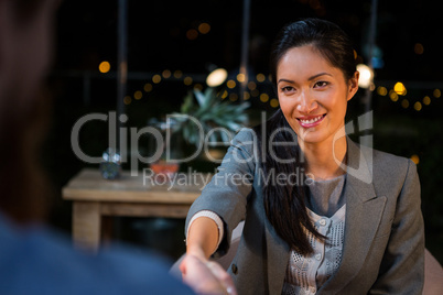 Businesswoman shaking hands with colleague