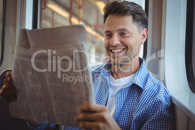 Handsome man reading newspaper