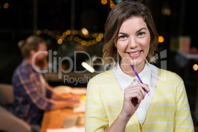 Portrait of businesswoman holding pencil