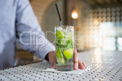Close-up of man holding glass of gin