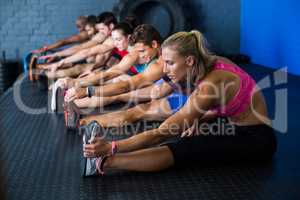 Side view of athletes stretching