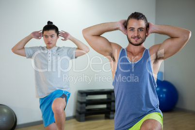 Smiling two men doing aerobic exercise