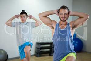 Smiling two men doing aerobic exercise