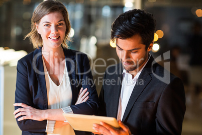 Businessman discussing with colleague over digital tablet