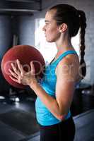 Side view of young athlete holding exercise ball