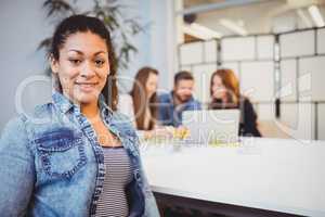 Businesswoman sitting against coworkers in meeting room