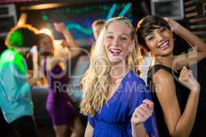 Two beautiful women dancing on dance floor