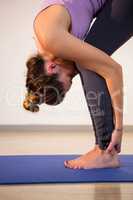 Woman performing standing forward bend