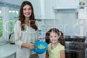 Mother and daughter with bowl of breakfast