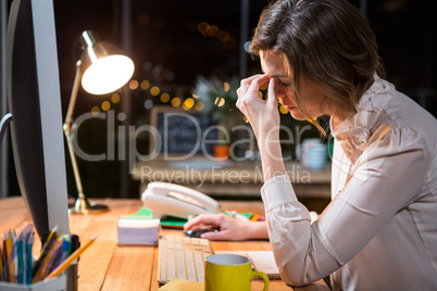 Stressed businesswoman sitting at her desk