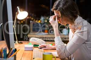 Stressed businesswoman sitting at her desk