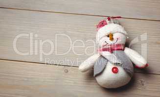 Close-up of snowman on wooden table