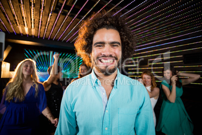 Smiling man standing in dance floor