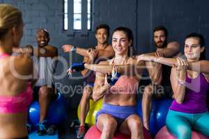 Athletes smiling while exercising in gym