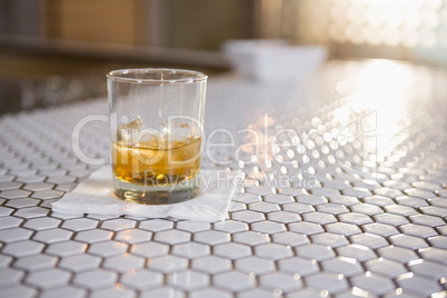 Glass of whisky on bar counter