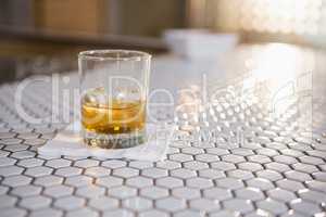 Glass of whisky on bar counter
