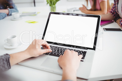 High angle view of executive using laptop at office