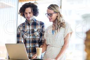 Couple using laptop in cafÃ?Â©