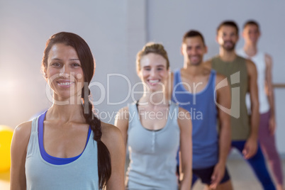 Group of fitness team posing in fitness studio