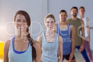 Group of fitness team posing in fitness studio